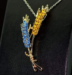 Брошка в позолоте з жовто-голубыми фианитами Брошка в позолоте з жовто-голубыми фианитами